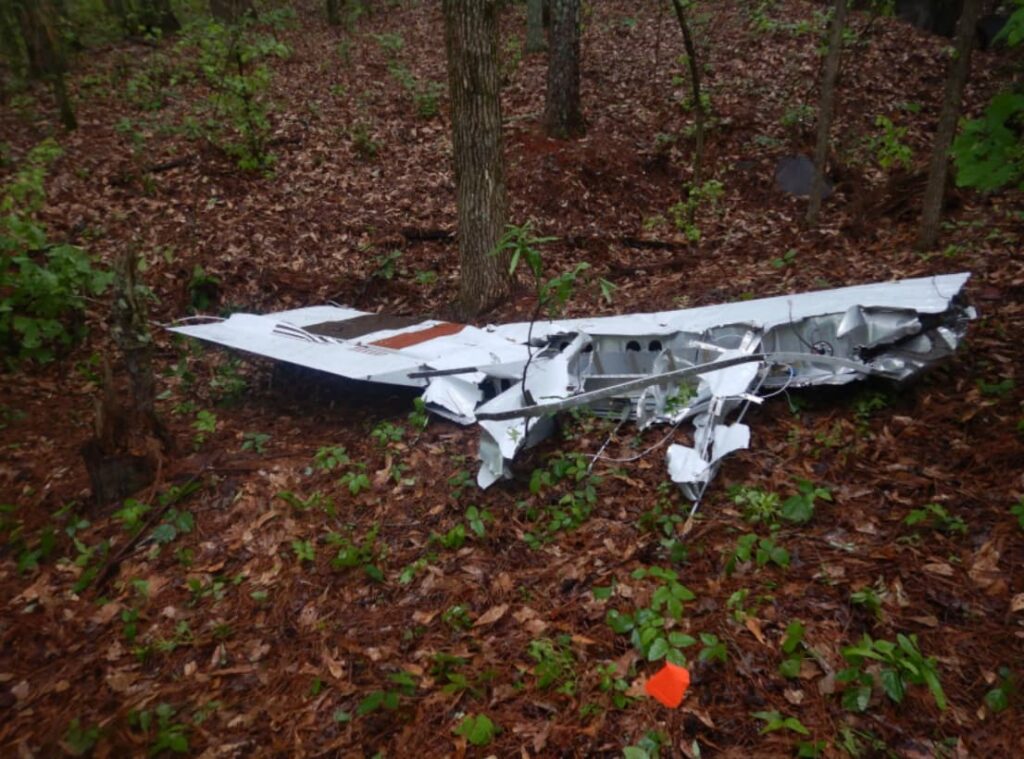 Section of right wing from Cessna 177B N123DS resting in wooded area, separated from main wreckage during in-flight structural failure caused by spatial disorientation.